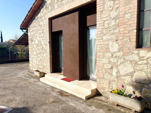 a brick building with a door and a window at MP home in Le Grazie