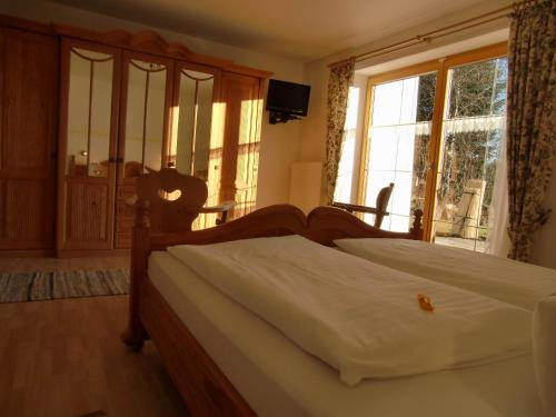 a bedroom with a bed and a large window at Fewo Bergruah in Bad Bayersoien
