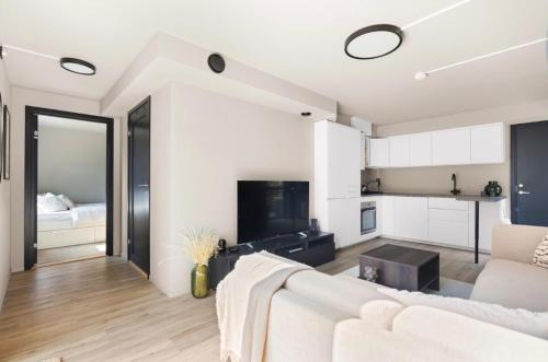 a living room with a couch and a kitchen at Modern apartment with two bedrooms in Hektner
