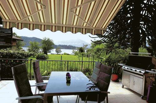 a table and chairs on a patio with a view at Casa Favorita in Colico