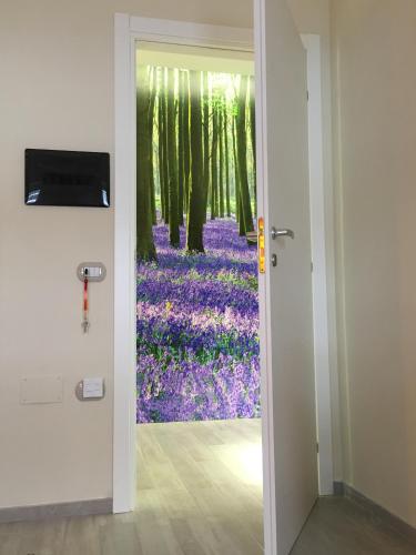a door leading into a room with purple flowers at Morra's Home in Naples