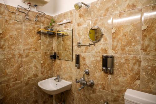 a bathroom with a sink and a mirror at Fussed Over Retreat in Siliguri