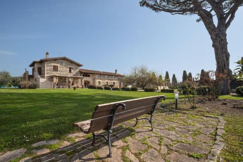 a park bench sitting in front of a house at Casale Elisa Country Hotel in Ladispoli