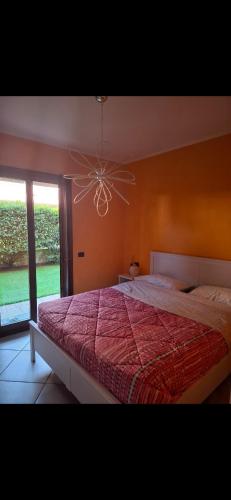 a bedroom with a large bed and a chandelier at Gg Home in Sirmione