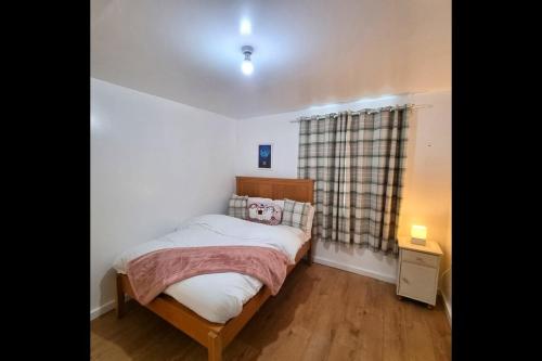 a small bedroom with a bed and a window at Peace Guest House in Hoo