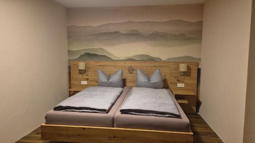 a bedroom with a bed with a painting on the wall at Hotel Bergkristall in Willingen