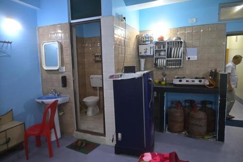 a small kitchen with a sink and a toilet at 3 Sixty House in Bodh Gaya