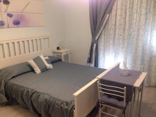 a small bedroom with a bed and a chair at Floreo Guest House in Rome