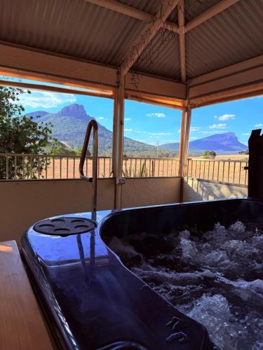 a bath tub with a view of a mountain at Southern Grampians Lookout in Dunkeld