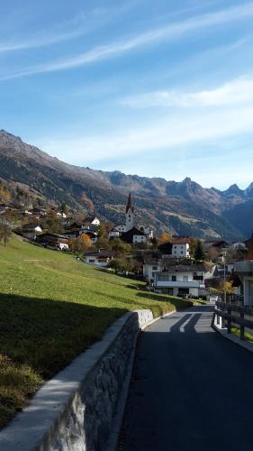 a road leading to a small village with a church at Apart Kaunergrat in Kauns