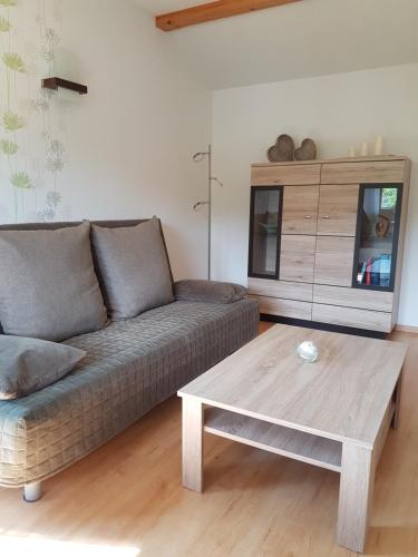 a living room with a couch and a coffee table at Haus Talsperreneck in Stützengrün