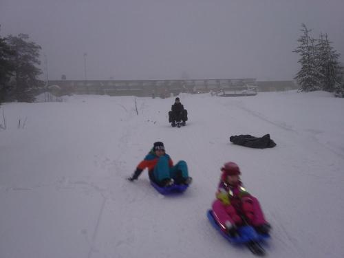 a group of people riding on a snowmobile in the snow at Karemajat Cottage Resort in Ylitornio