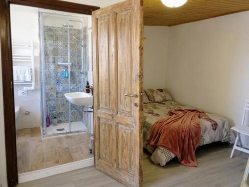 a bedroom with a bed and a bathroom with a shower at La Chiave del Gufo - Bojano in Boiano