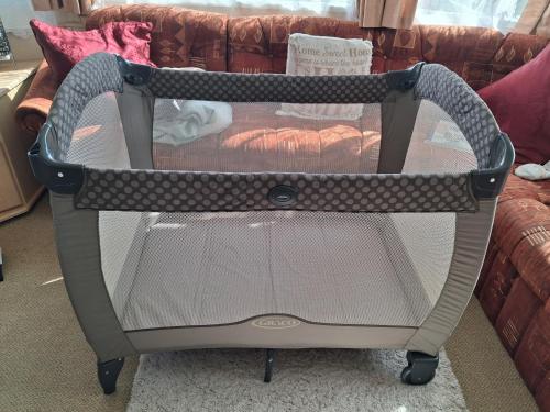 a baby carrier sitting on a couch at Sandhills Holiday Park Astounding Sea Views in Bembridge