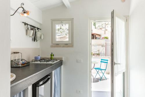 a kitchen with white walls and a counter top at Scicli Albergo Diffuso in Scicli