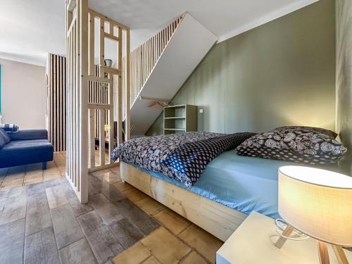 a bedroom with a bed and a staircase at Chez La Mamie in Saint-Jean-de Niost