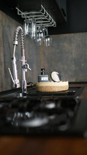 a kitchen sink with a faucet and a sponge at Cocon cosy hyper-centre idéal 4 personnes in Tours