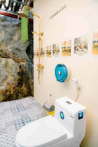 a bathroom with a white toilet and a sink at The Hive Homestay - Tam Coc in Ninh Binh