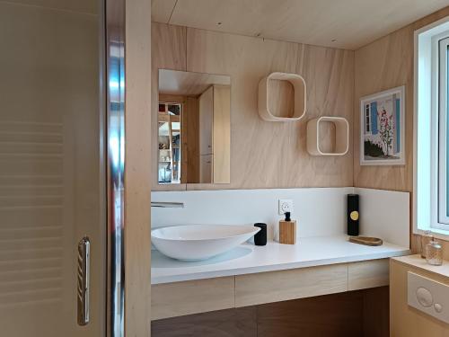 a bathroom with a sink and a mirror at Tiny house Oléroncoast La-Brée-Les-Bains in La Brée-les-Bains