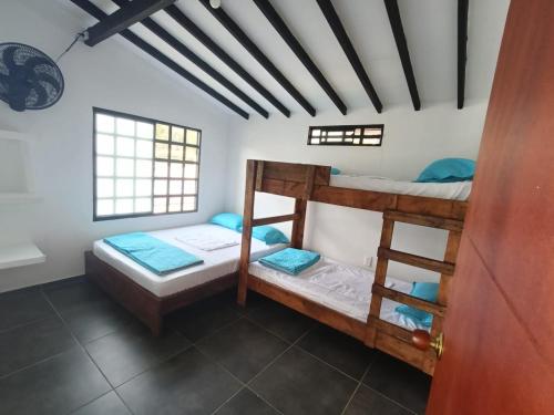 a room with two bunk beds in it at Shaddai Villeta Centro Ecoturistico in Villeta