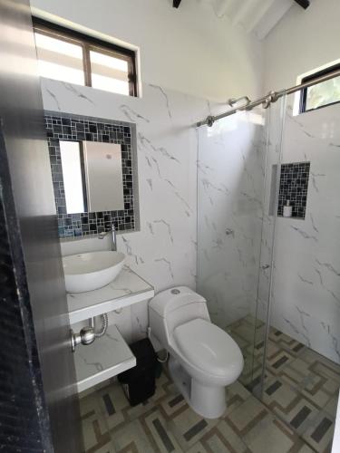 a bathroom with a toilet and a sink and a shower at Shaddai Villeta Centro Ecoturistico in Villeta