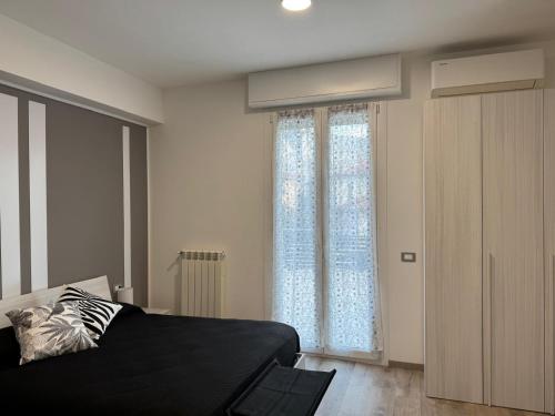 a bedroom with a bed and a large window at EDEL Vacation Home in Terni