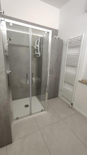 a shower stall with a glass door in a bathroom at Casa Nulfa in Sommacampagna