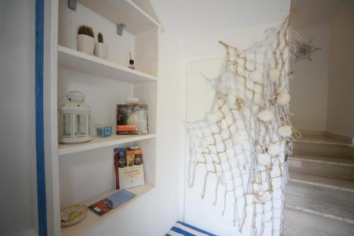 a refrigerator with shells hanging on the wall at B&B Gli Alberetti in Loreto
