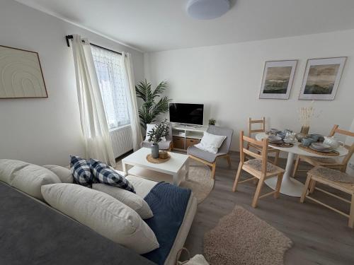 a living room with a couch and a table at Apartmány Loučky Litvínov in Litvínov
