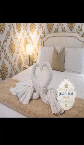 two swans made out of towels on a bed at Jessica Flat Malta Royal Guesthouse in Cospicua