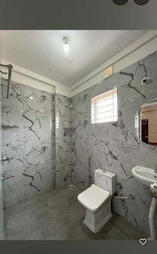 a bathroom with a toilet and a sink at Sanvi studio rooms in Bangalore
