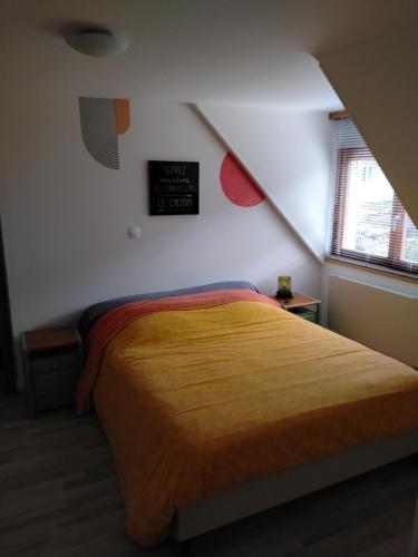 a bedroom with a bed and a clock on the wall at Les gîtes d'Esika in Rimbach-près-Masevaux