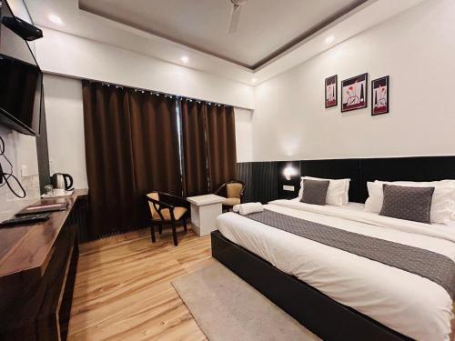a hotel room with a bed and a desk at Banj View Resort in Mussoorie