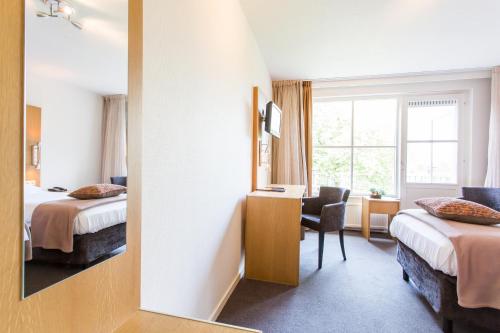Postel nebo postele na pokoji v ubytování Hotel Restaurant Ruimzicht