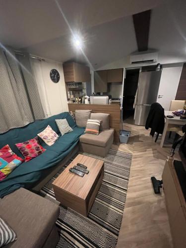 a living room with a couch and a table at Mobile-home in Gassin