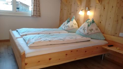 a bedroom with two beds in a wooden room at Appartment Iris in Aich