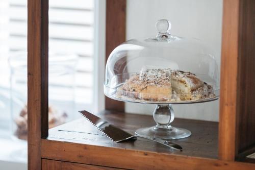 a cake in a glass display case on a table at Euterpe LHT in Agrigento
