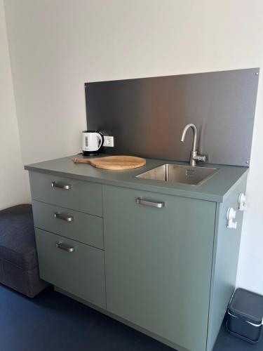 a kitchen with a sink and a counter top at Het Hunebedje in Vries