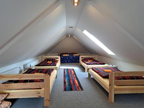 a room with four beds in a attic at Pension Garage in Kutná Hora