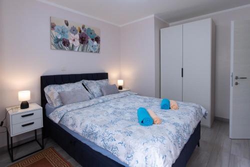 a bedroom with a large bed with blue pillows at Emma in Krasica