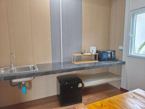 a kitchen with a counter top with a sink at Wangpocamping วังโพแค้มป์ปิ้ง in Ban Wang Pho