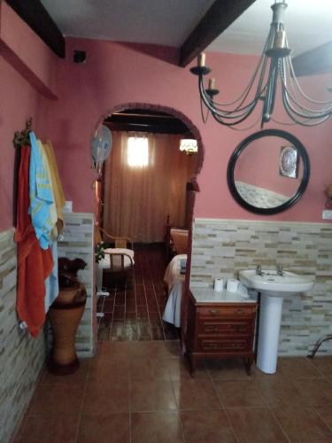 a bathroom with a sink and a mirror at Casa rural las conchas in Cazalla de la Sierra