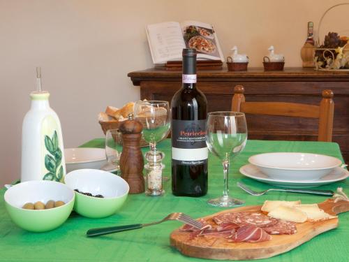 a table with a bottle of wine and a plate of food at Fattoria Poggio Capponi in Montespertoli