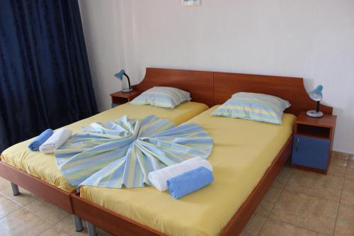 a bedroom with two beds with towels on them at Villa Amadeus in Nesebar