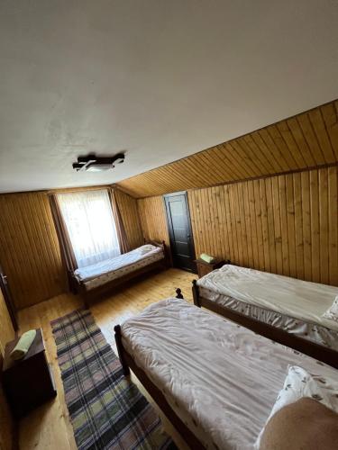 a room with two twin beds and a window at У Блищака in Pilipets