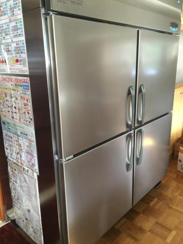 a stainless steel refrigerator in a kitchen at Kagura House in Yuzawa