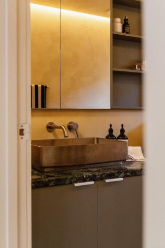 a kitchen counter with a sink and a cabinet at Kodok House in Melbourne