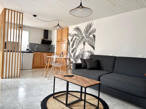 a living room with a couch and a table at T2 Cosy in Mende