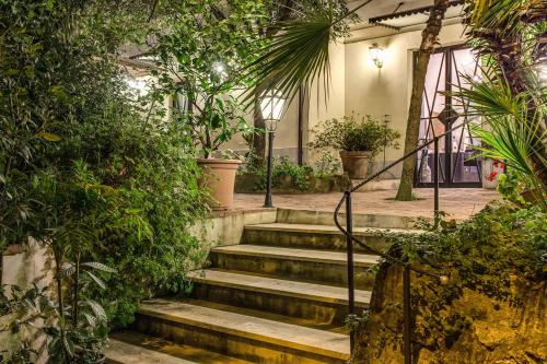 a set of stairs in a building with plants at Hotel Villa Linneo in Rome