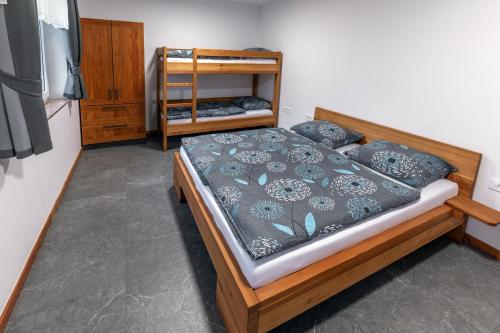 a bedroom with a wooden bed with pillows at Apartmaji Peternelj in Železniki